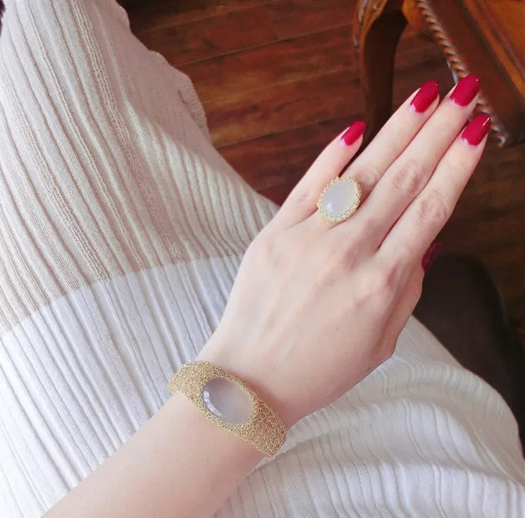 14k gold wire natural white chalcedony bracelet with adjustment chain on neutral background