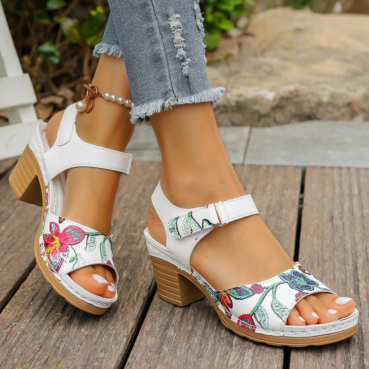 White women's high heel sandals with an adjustable Velcro strap buckle on the ankle.