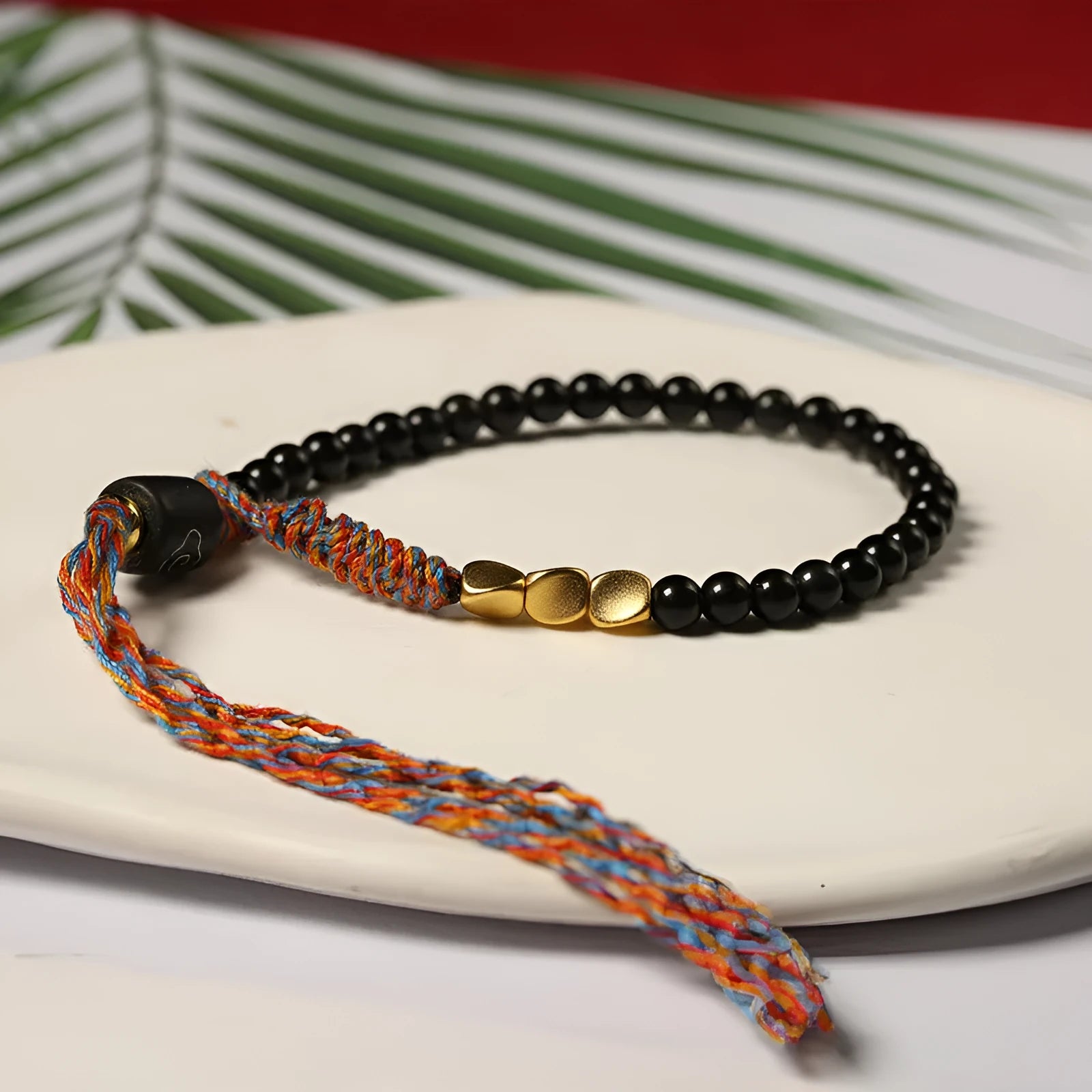 Hand-woven obsidian carrying strap bracelet showing textured surface and 4mm width detail