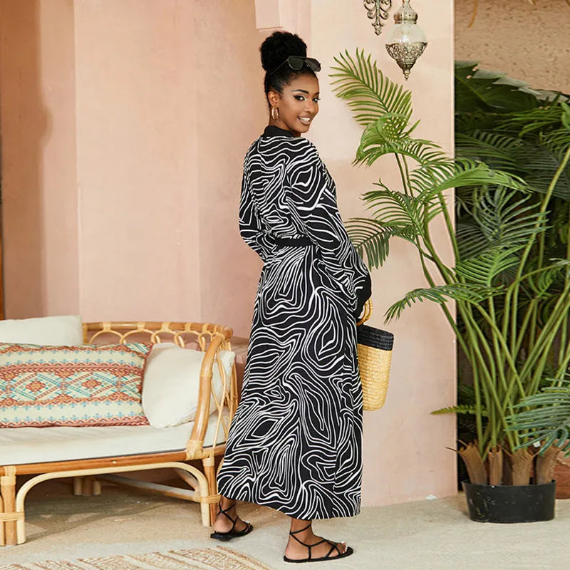 Printed beach cover-up in black white line design on a woman over a bikini, loose fit rayon-cotton tunic