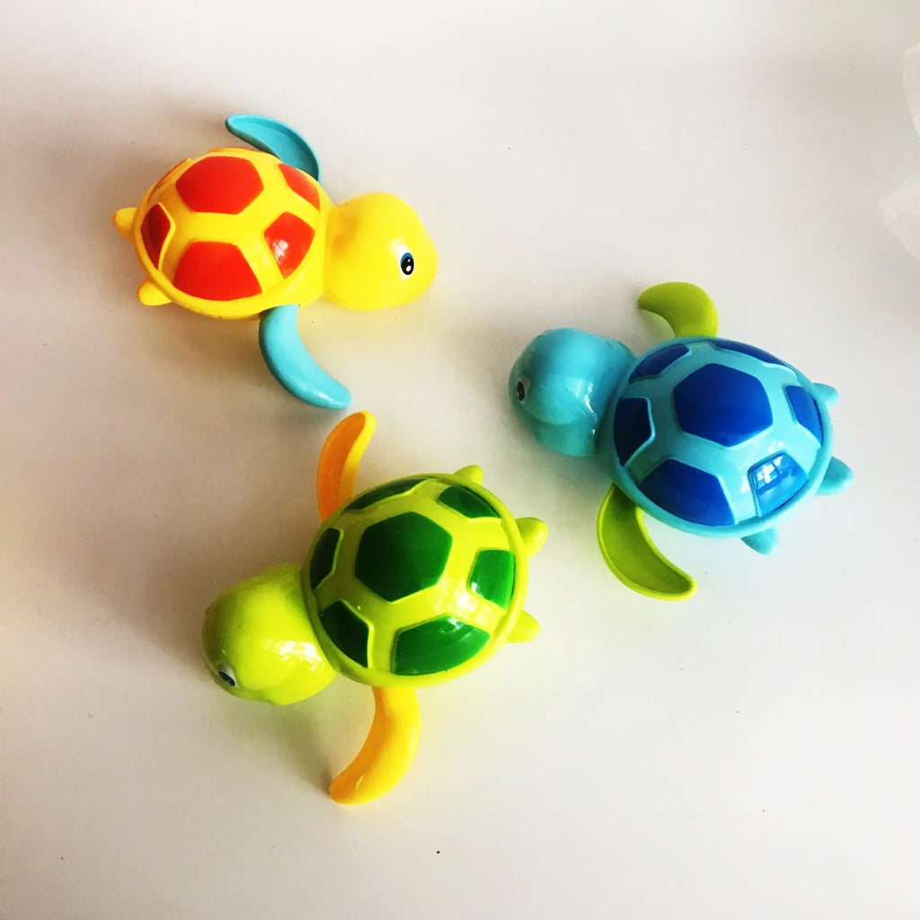 Yellow wind-up plastic turtle water toy on blue surface, 12cm clockwork mechanism