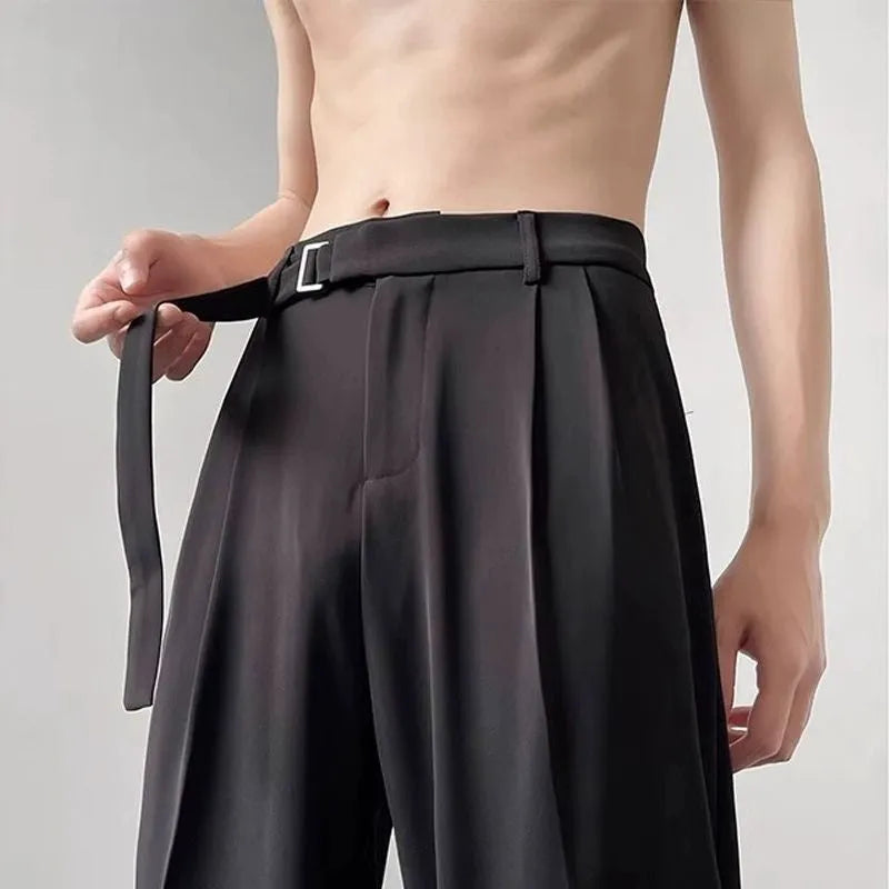 Black wide leg trousers with straight cut and non-iron finish laid flat