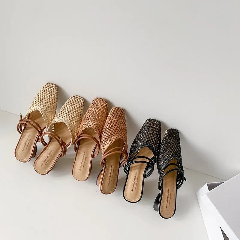 Women's black retro slippers with a square toe, chunky heel, and breathable hollow-out design on a rubber sole.