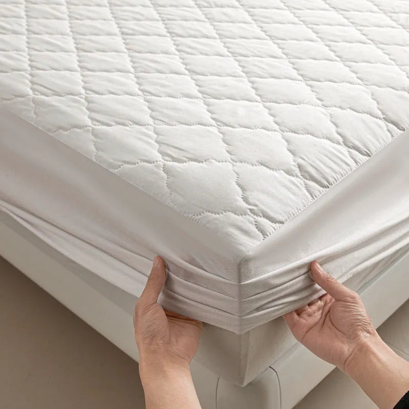 Diamond lattice quilted bamboo fibre waterproof mattress protector set with fitted sheet and pillowcases in grey.