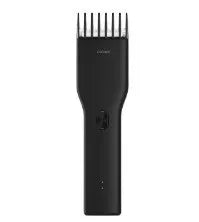 Black and white cordless Boost hair clipper with adjustable slider comb and nano ceramic cutter head.