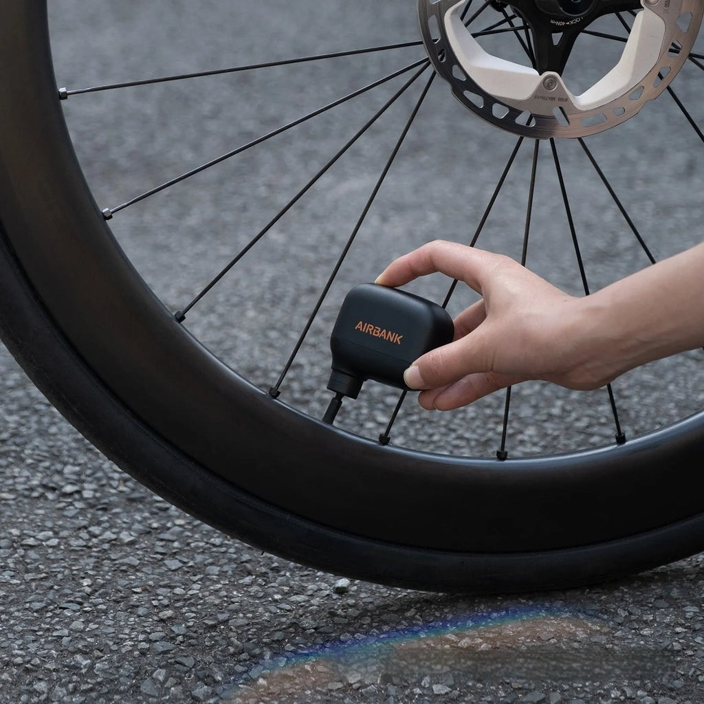 Black AS100 electric bicycle tyre inflator with USB cable and waterproof bag
