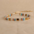 Geometric glass bead pull bracelet in retro green, black, light blue, red, and milky white colours.