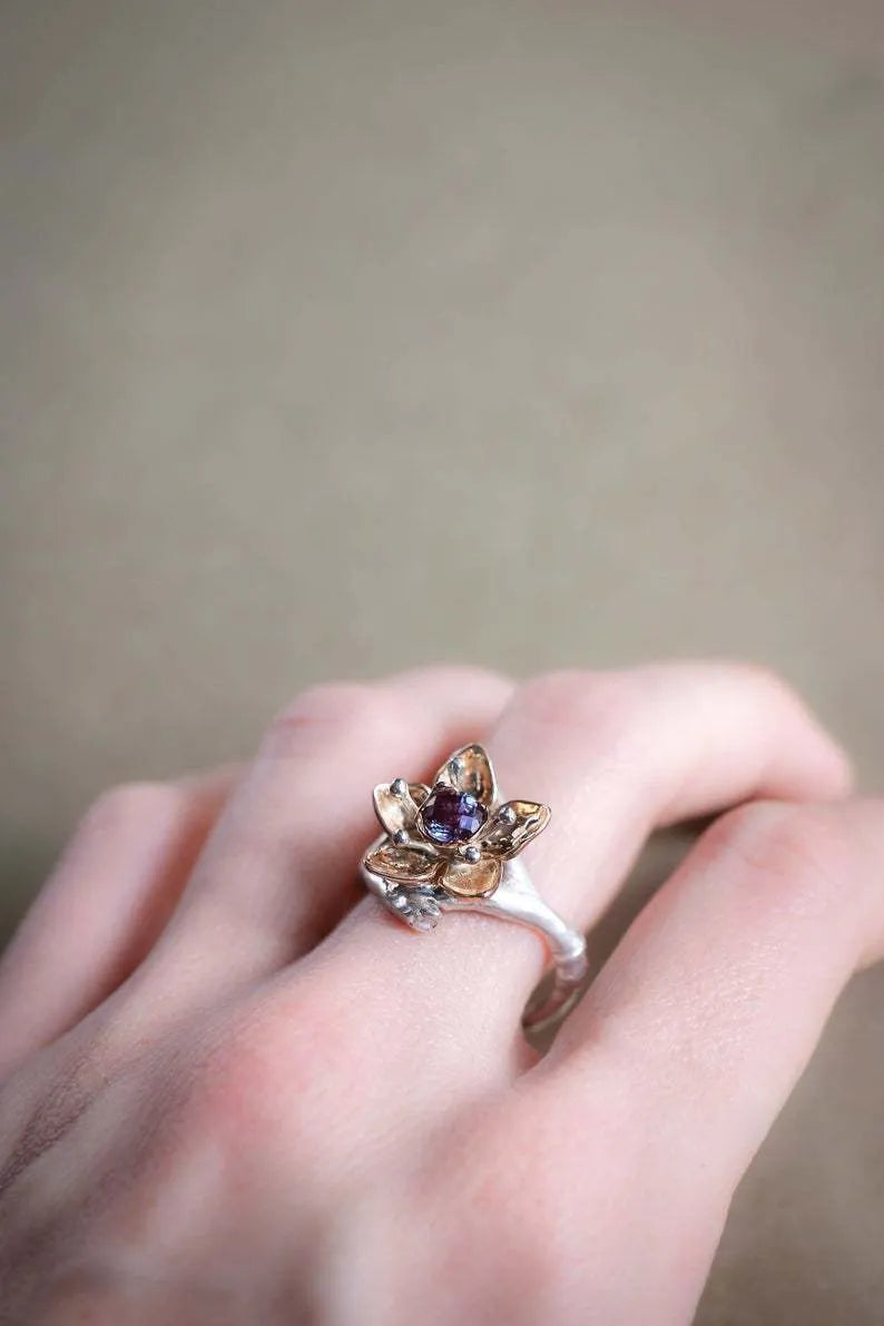 Silver two-tone women's alloy ring with geometric floral pattern, shown on a model finger.