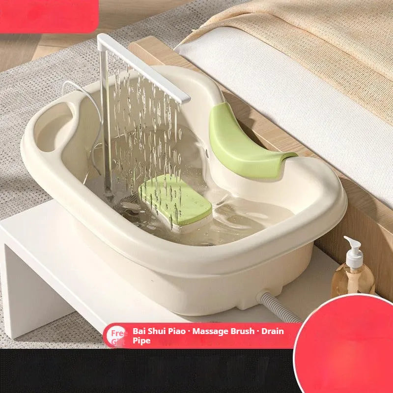 Light pink plastic shampoo basin for bed use with head pad, neck pillow, and water pump on bed