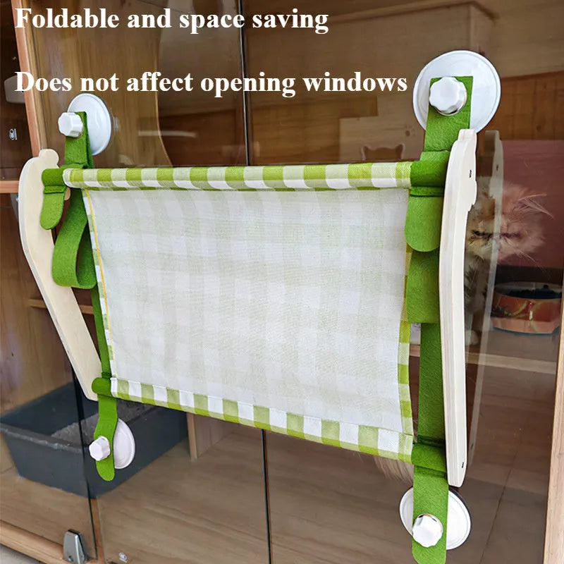 Pink wooden cat hammock bed with suction cups attached to a window
