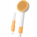 Green pet grooming brush with stainless steel bristles and hanging loop