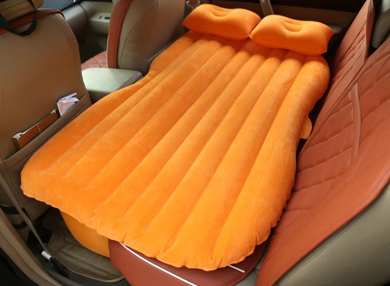 Ultra-thickened flocking cloth inflatable bed set up on a car rear seat with two pillows.