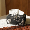 White Chinese brocade tissue box with embroidered plum blossoms, shown with and without a pearl buckle.