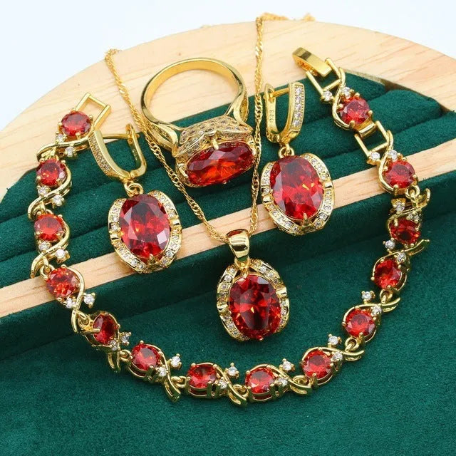 Olive green rhinestone jewellery set with necklace, earrings and ring featuring cross, crown and numeral designs.