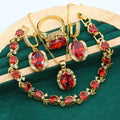 Olive green rhinestone jewellery set with necklace, earrings and ring featuring cross, crown and numeral designs.