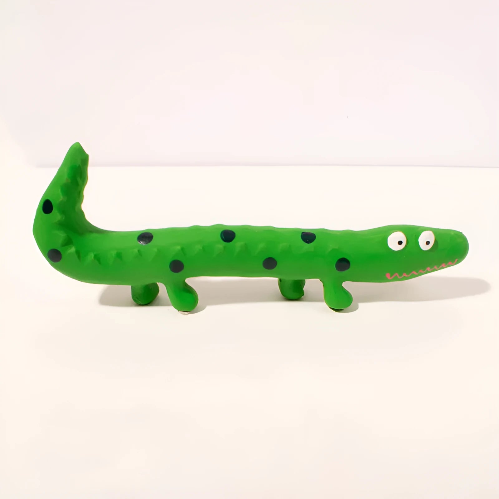 Green lizard-shaped dog chew toy with squeaker on a white background.