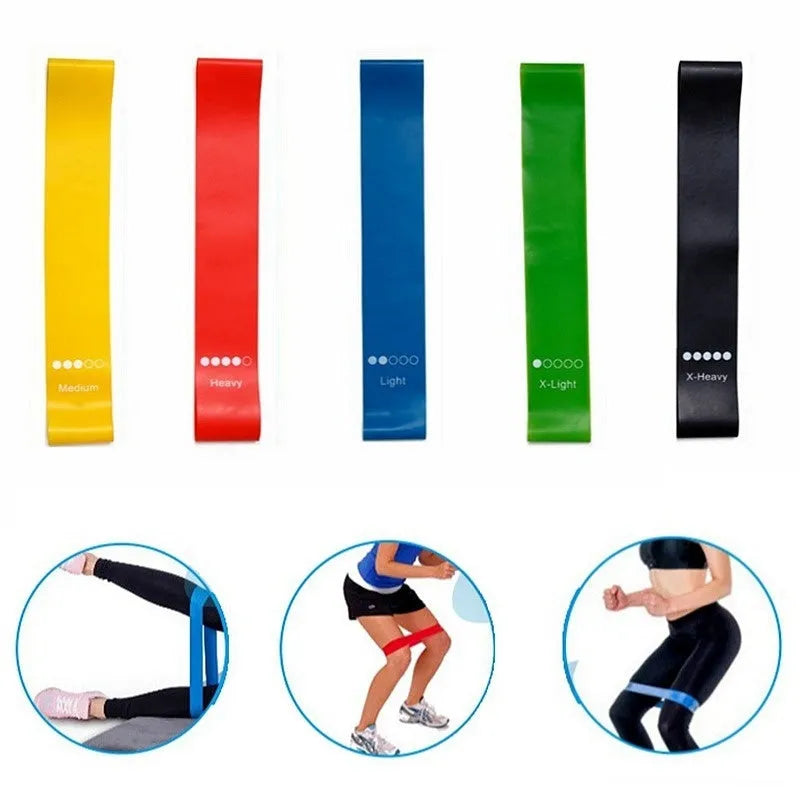 Five yoga resistance bands in different colours with varying thickness for progressive fitness training