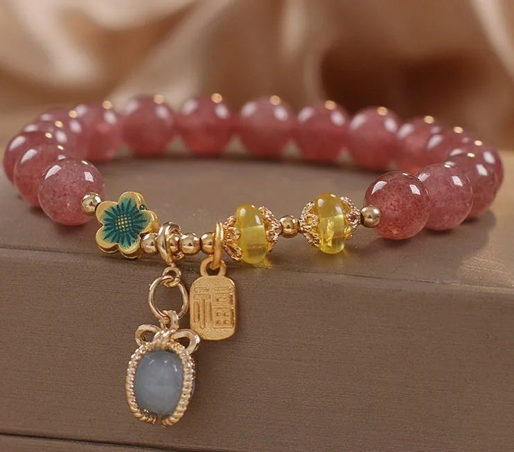 Red strawberry quartz design beaded bracelet for women with alloy metal and rhinestones.