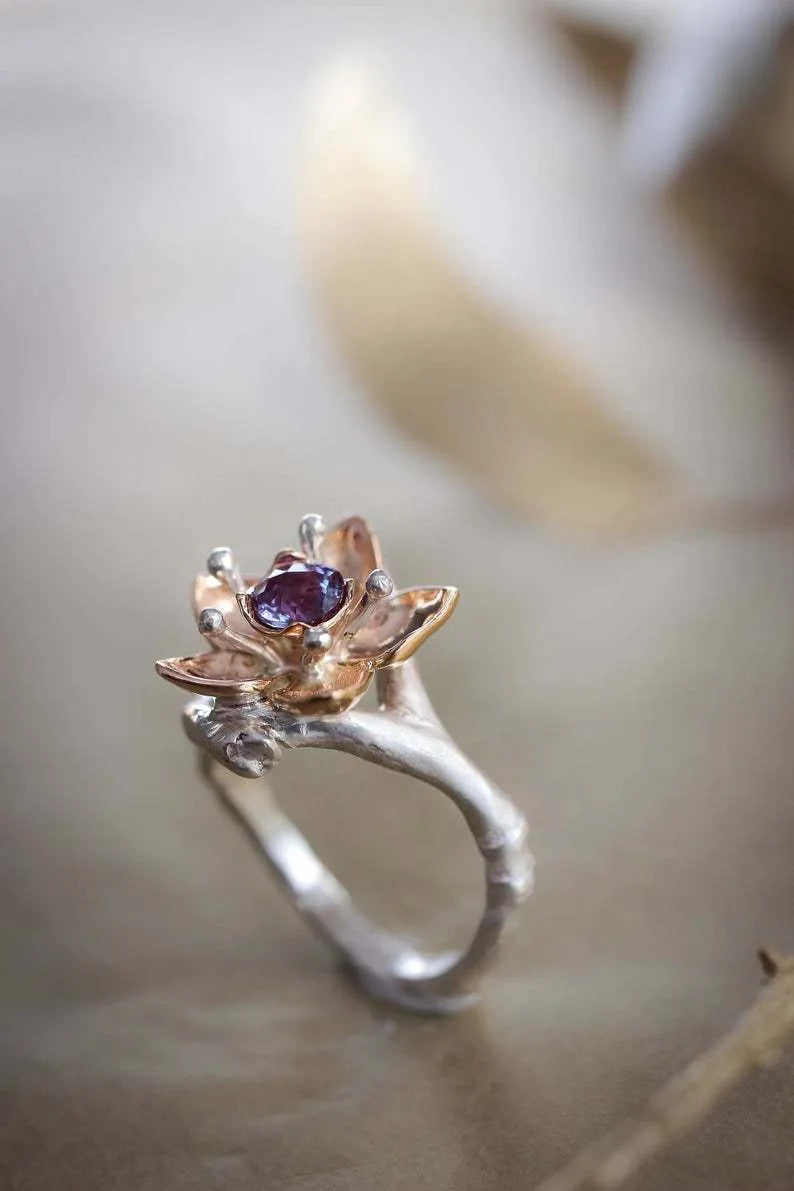 Silver two-tone women's alloy ring with geometric floral pattern, shown on a model finger.
