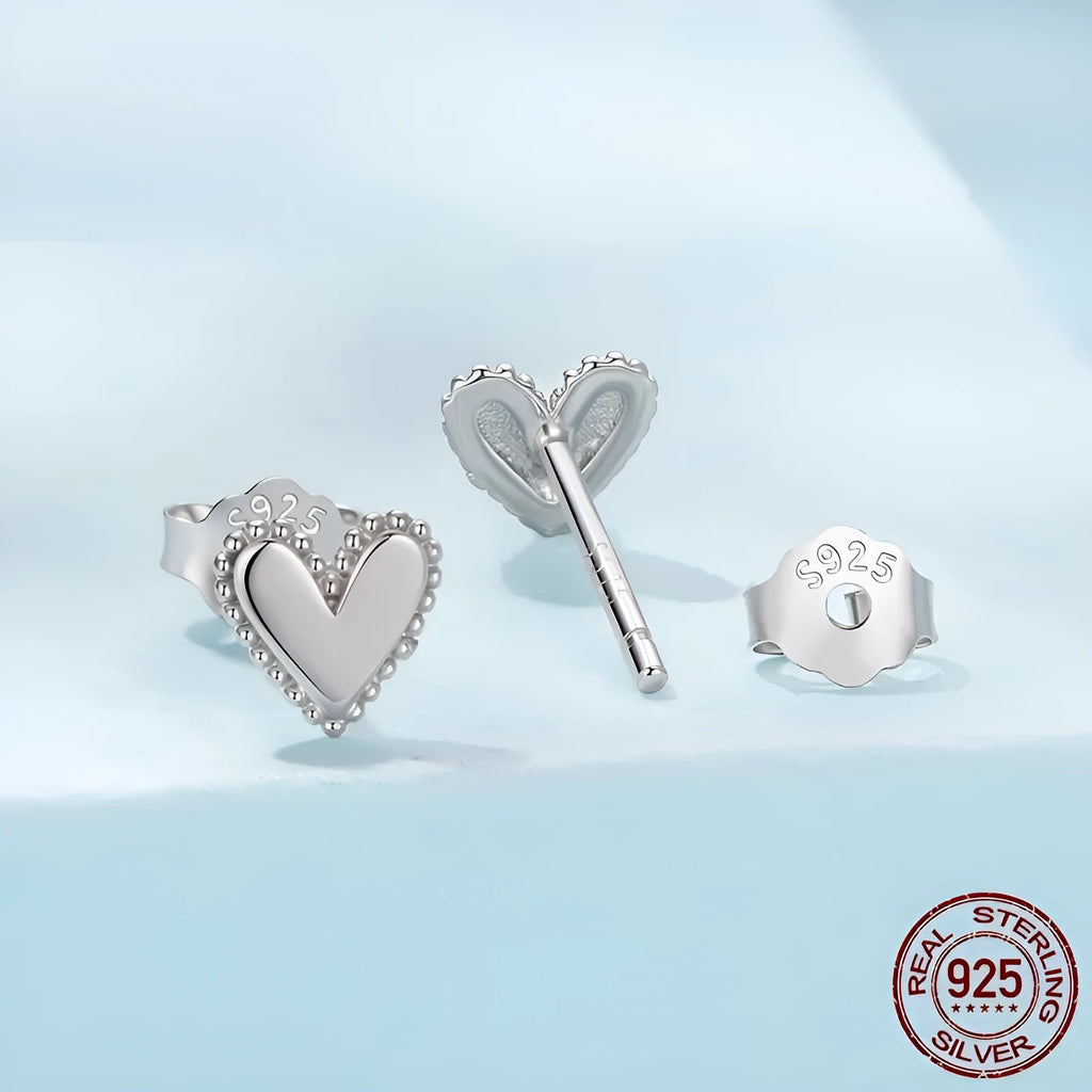 S925 sterling silver heart shaped stud earrings for women, electroplated finish, single pair on white background