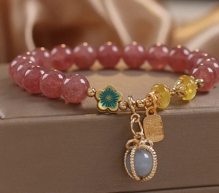 Red strawberry quartz design beaded bracelet for women with alloy metal and rhinestones.