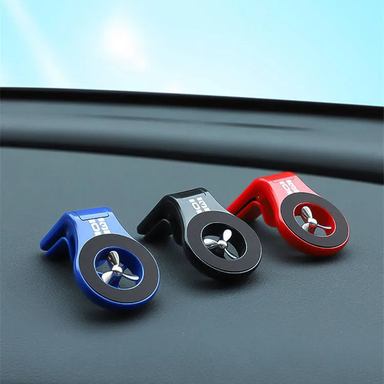 Magnetic car phone holder attached to vehicle air vent with phone mounted