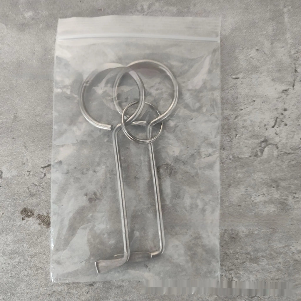 Two alloy wrench tools from a portable household tool set on a plain background.