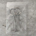 Two alloy wrench tools from a portable household tool set on a plain background.