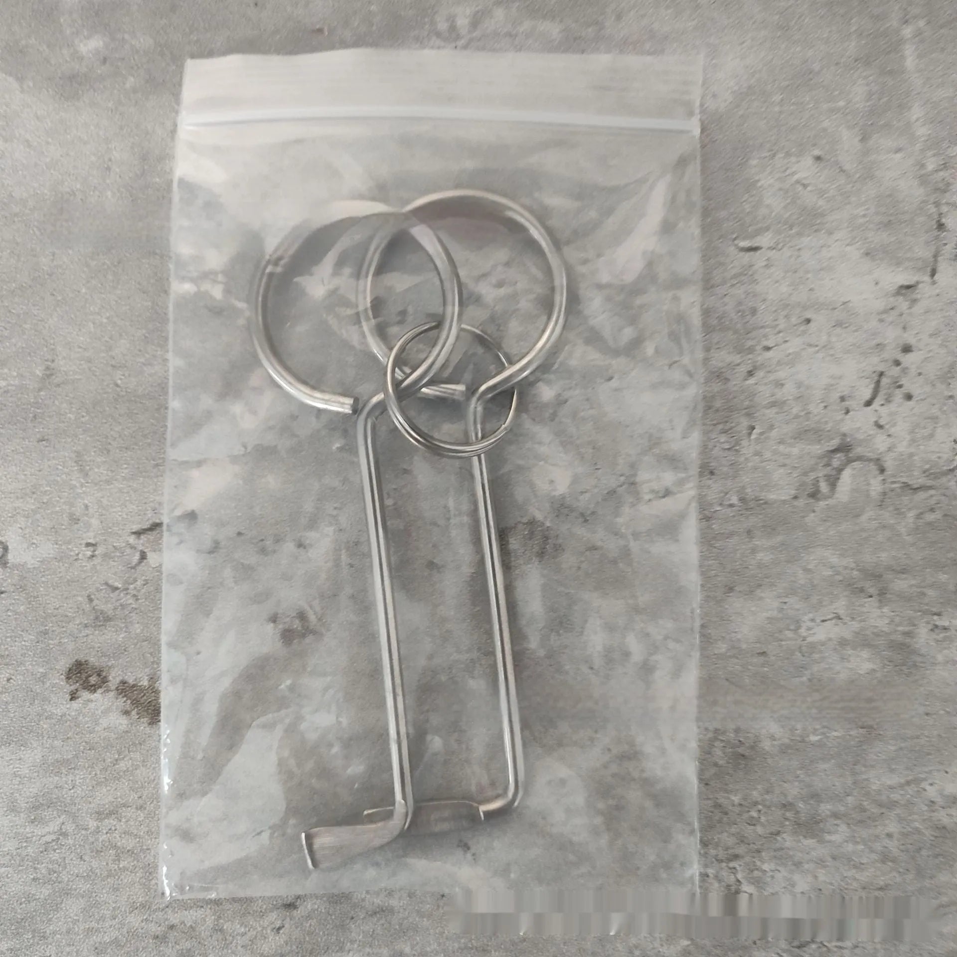 Two alloy wrench tools from a portable household tool set on a plain background.
