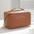 Vertical pattern pillow makeup bag with cubic shape measuring 22.5cm in PU material