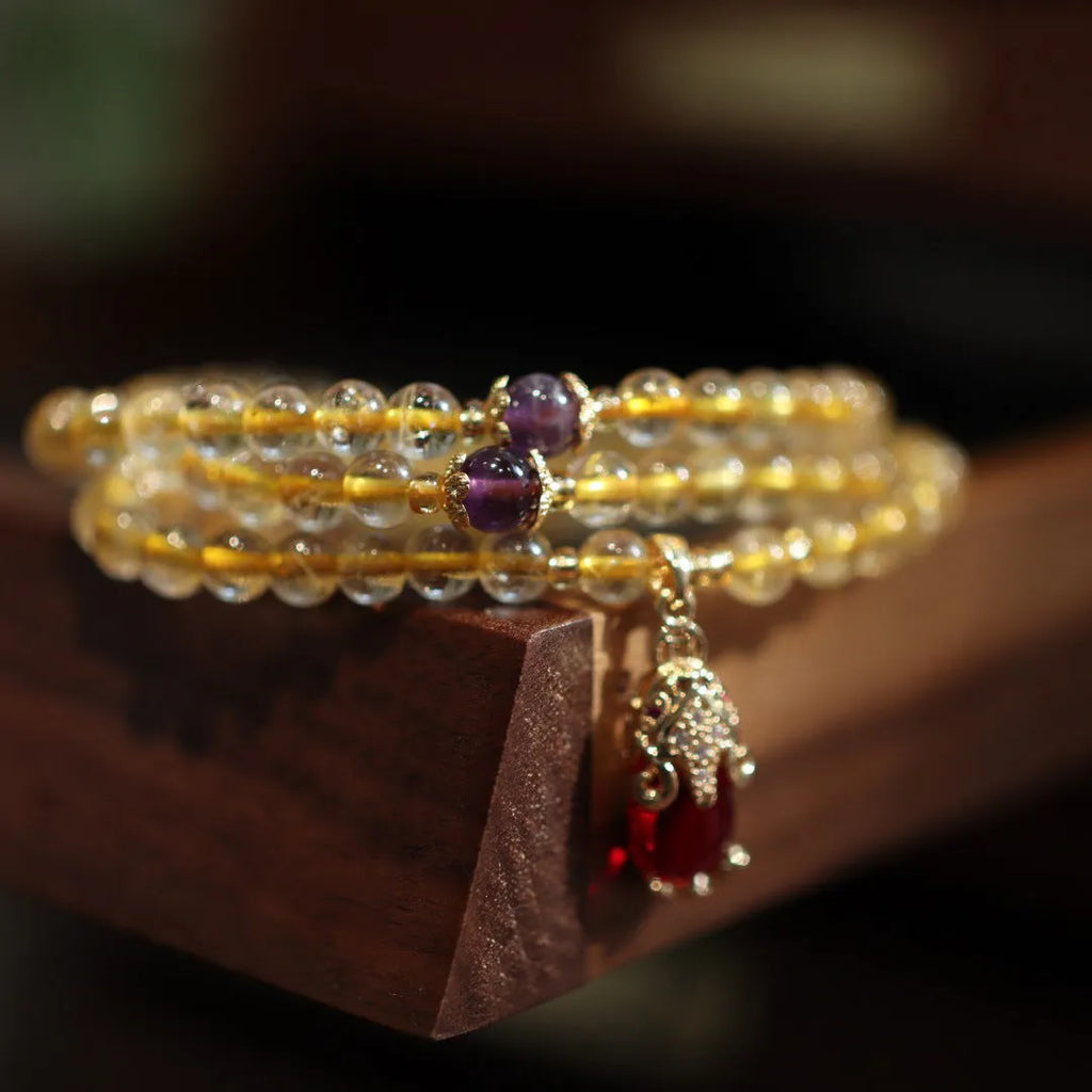 Natural gold rutilated quartz bracelet with hanging chopsticks design