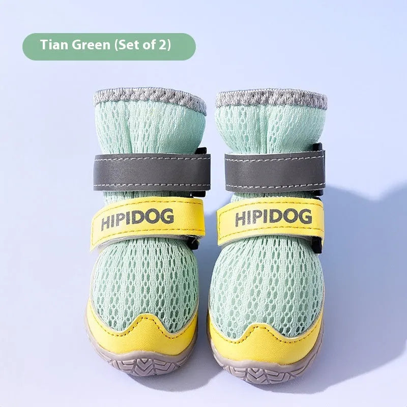 Pair of blue and green cartoon style dog shoes made from PU material on a white background.