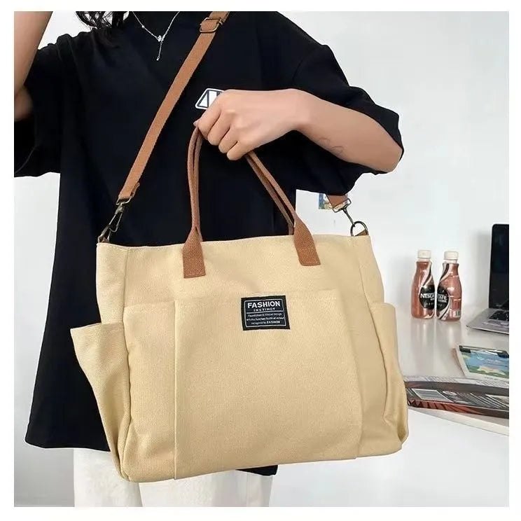 Canvas shoulder bag in khaki, 31cm wide, with handle and crossbody strap, urban simplicity style