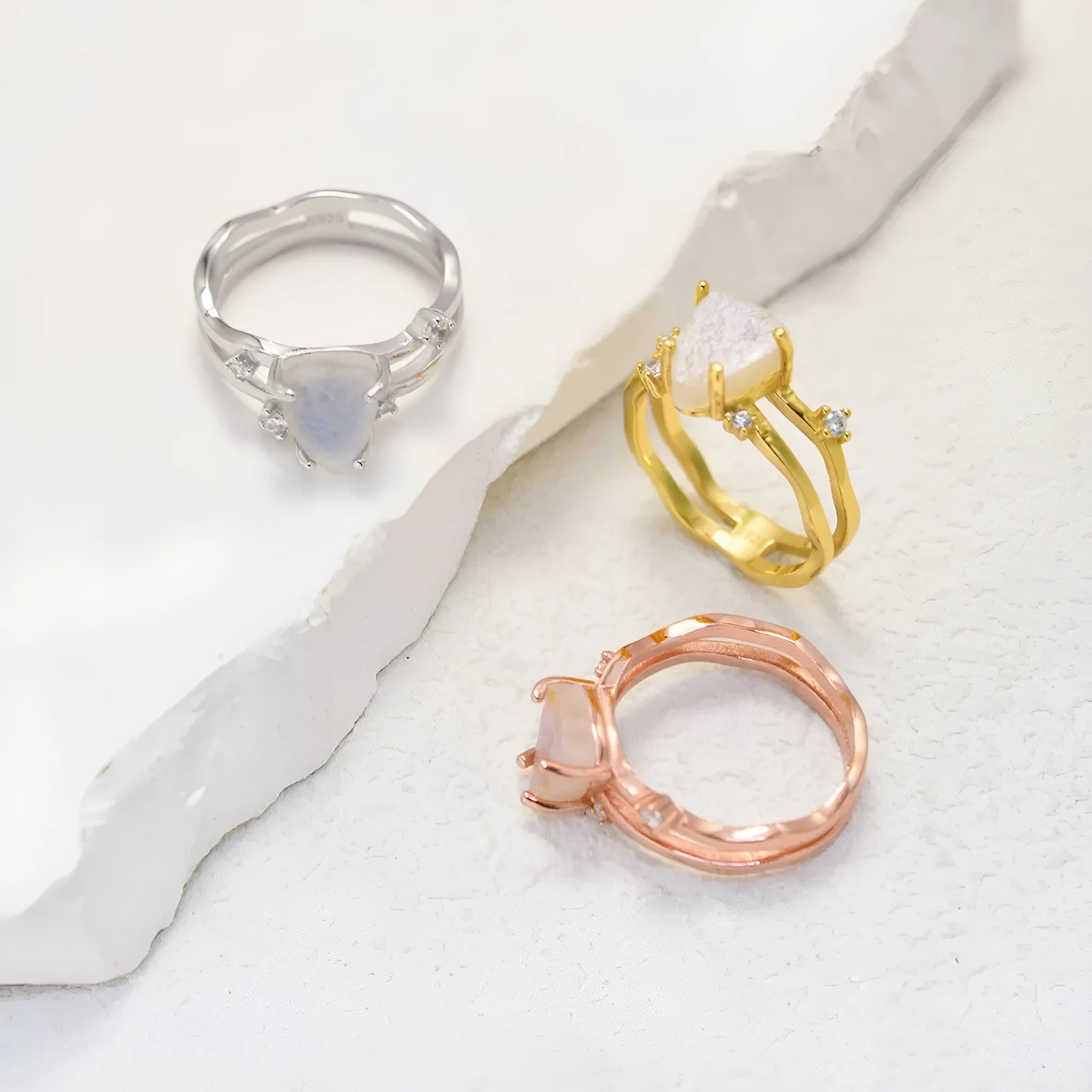 S925 silver irregular triangle moonstone ring in rose gold, white gold, or yellow gold colour on a hand.
