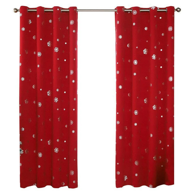 Red snowflake pattern shade cloth curtain with lace loop detailing hung on window