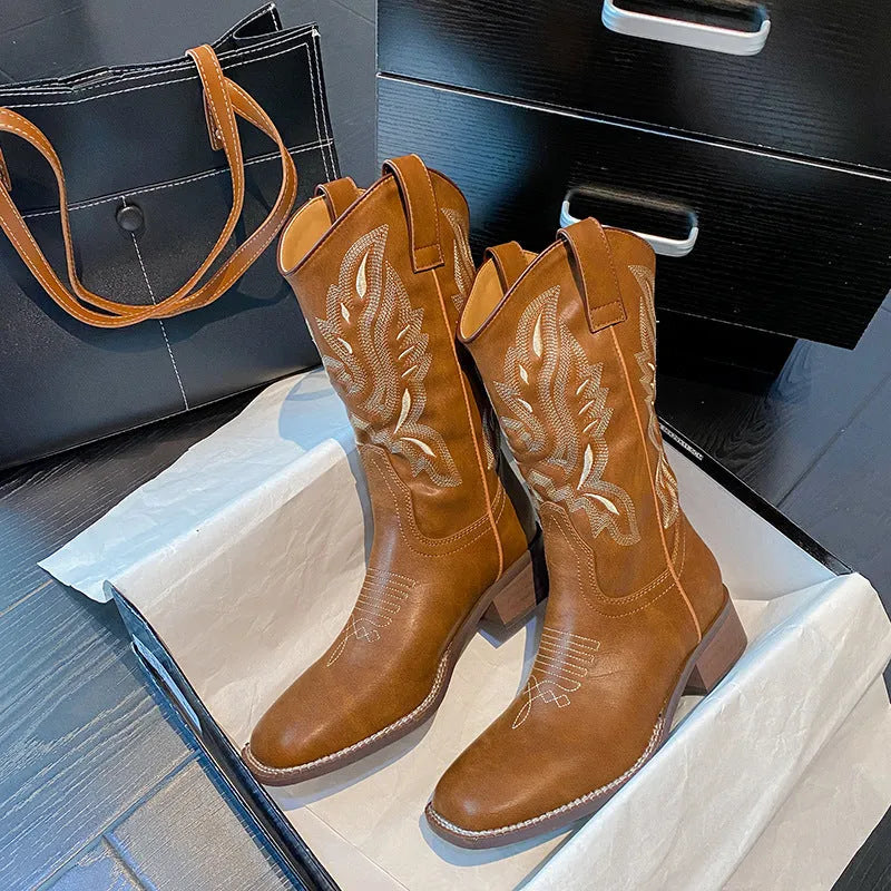 Brown women's embroidered leather mid-calf boots with round toe and low square heel.