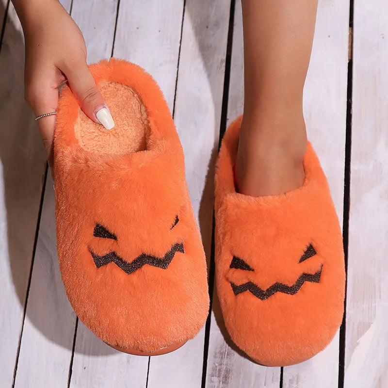 Orange Halloween pumpkin slippers with plush lining and textured PVC sole.
