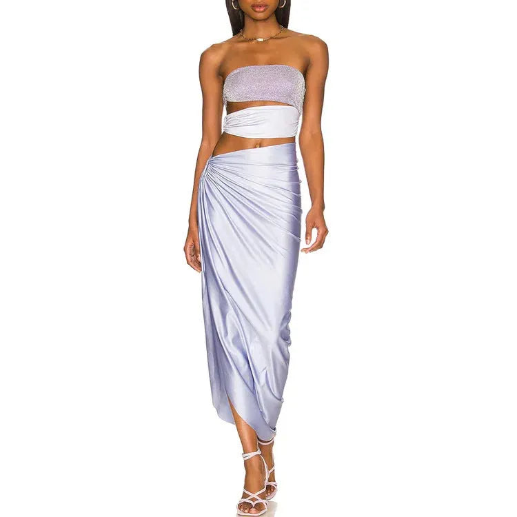 Purple one-piece swimsuit with a matching wrap skirt laid flat on a surface.