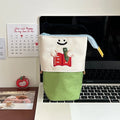 Brown and green collapsible cartoon pencil case made from Oxford fabric, shown with dimensions 17cm by 14cm.