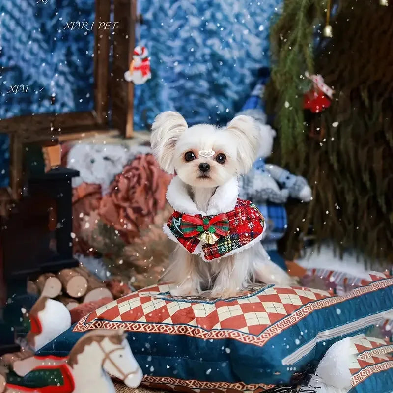 Red polyester pet scarf with white snowflake bell design wrapped around a dog's neck.