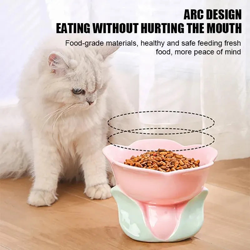 Blue floral patterned ceramic raised pet bowl for cats and dogs on a wooden floor.