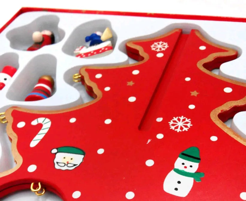 Hand-painted wooden Christmas tree decoration in red and green colours on desktop