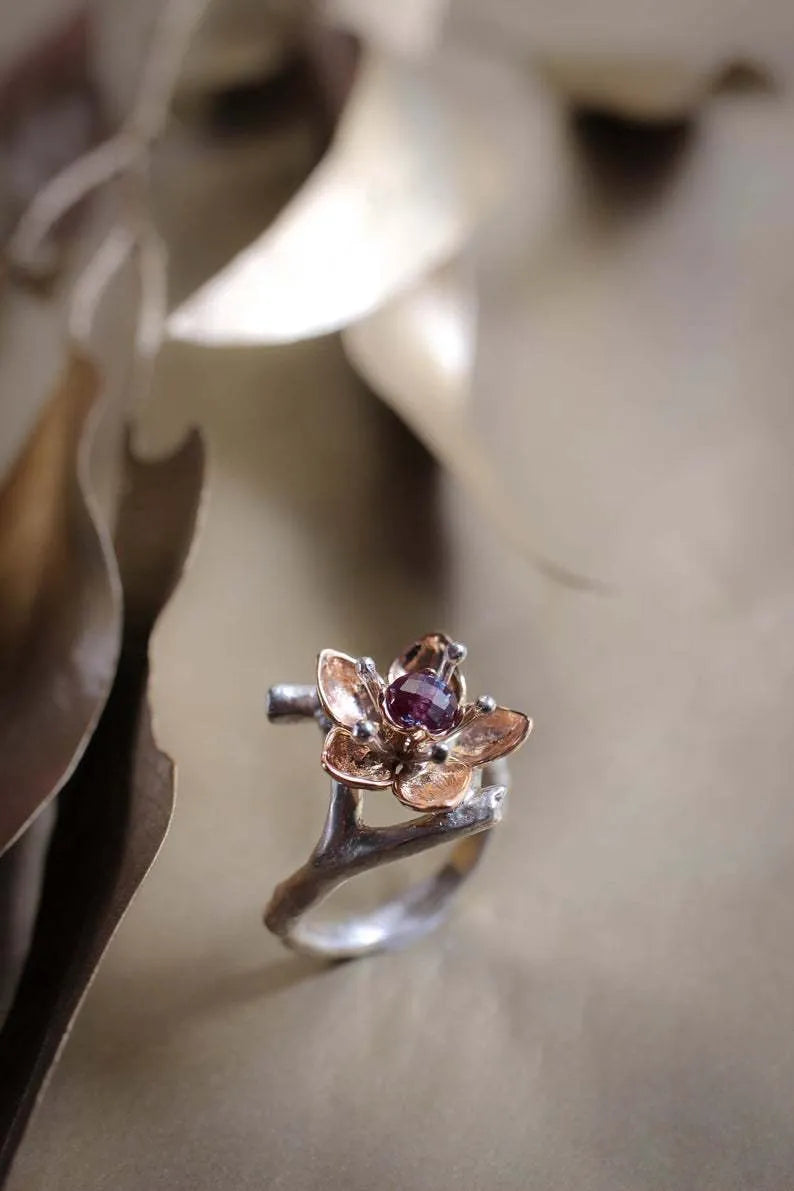 Silver two-tone women's alloy ring with geometric floral pattern, shown on a model finger.