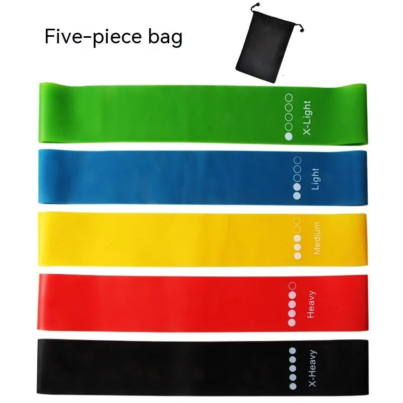 Five yoga resistance bands in different colours with varying thickness for progressive fitness training