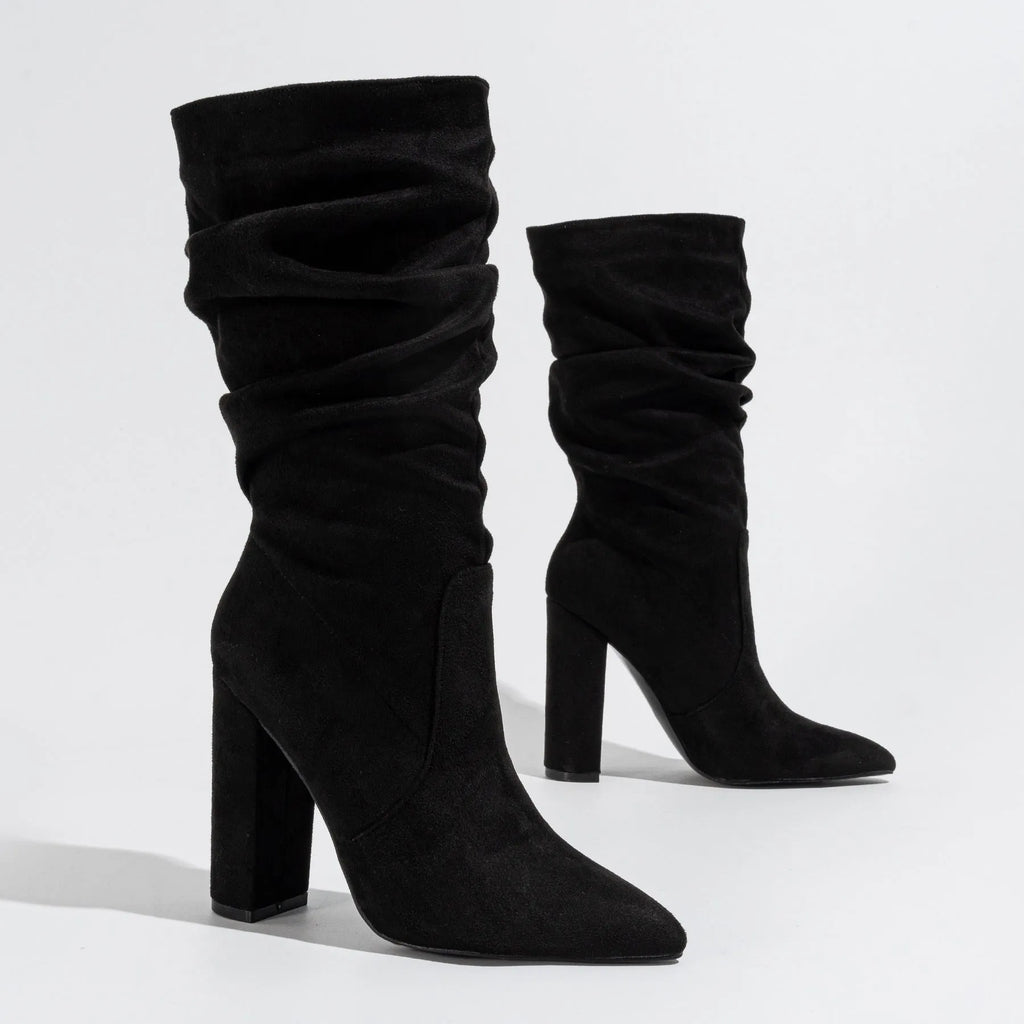 Women's black suede ankle boots with a chunky high heel and pointed toe.
