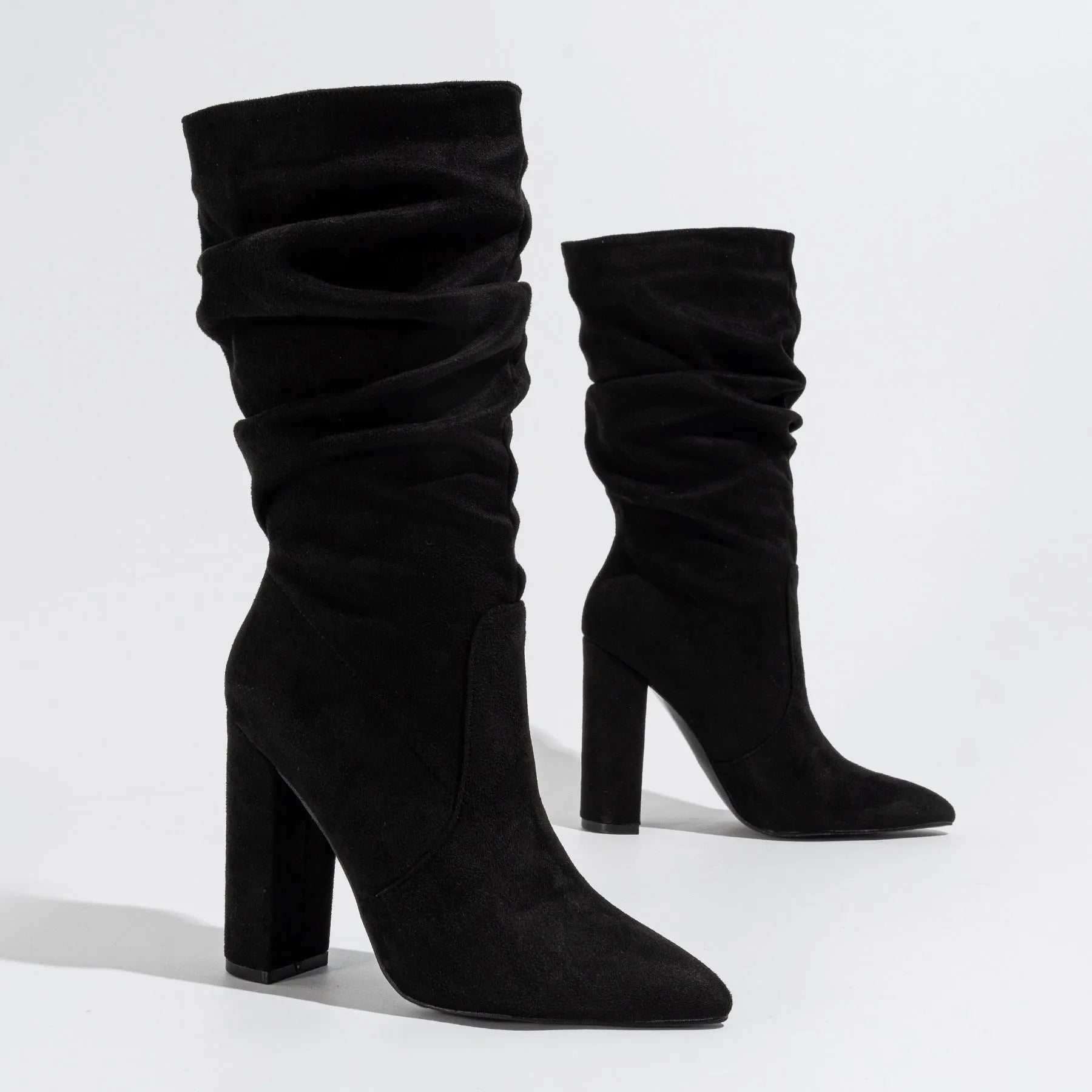 Women's black suede ankle boots with a chunky high heel and pointed toe.