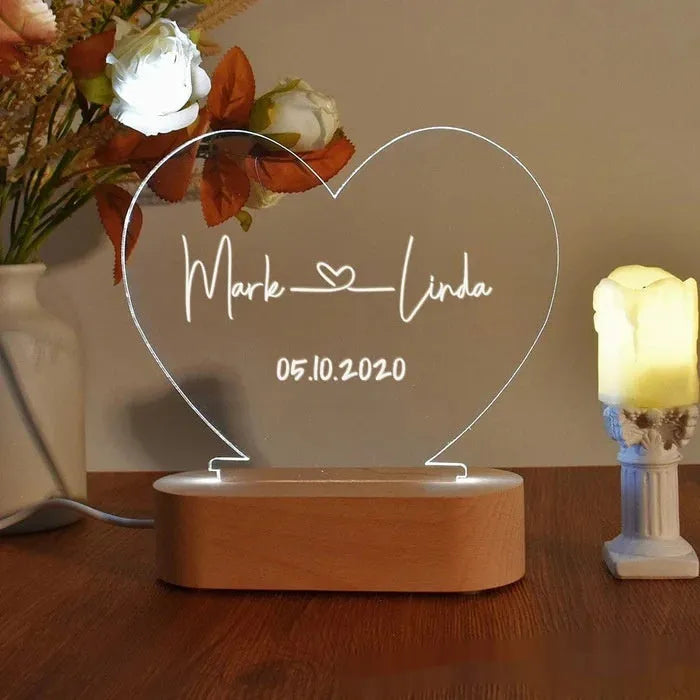 Personalised acrylic night light with engraved names and dates, measuring 20cm by 11.5cm