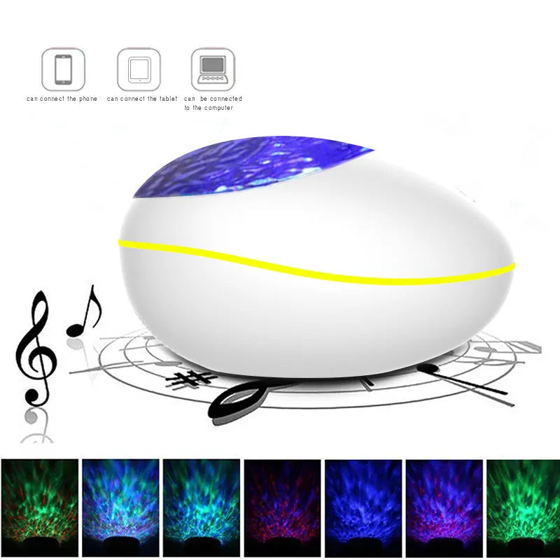 Black ocean wave projector LED night light with Bluetooth speaker and remote control on a table