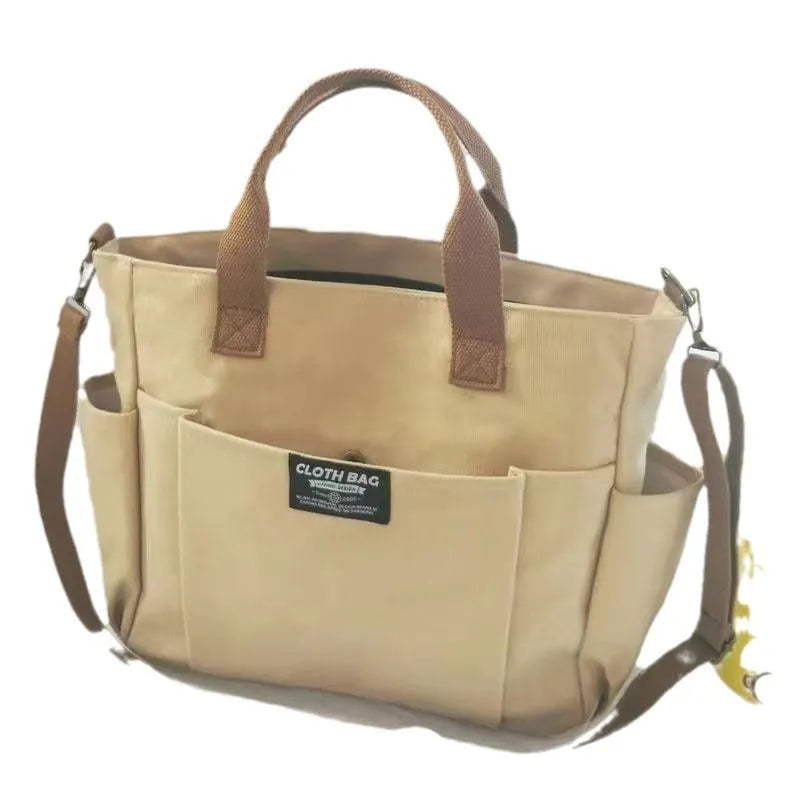 Canvas shoulder bag in khaki, 31cm wide, with handle and crossbody strap, urban simplicity style