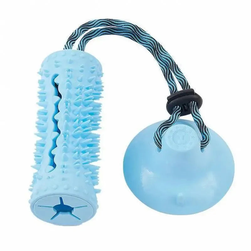 Blue and pink dog chew ball toy with suction cup and food dispenser on tiled floor